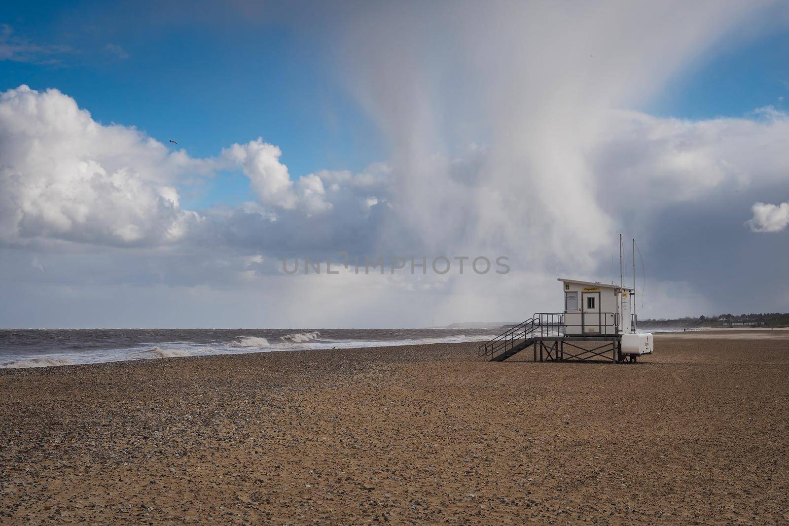 Hail storm above lifeguard hut on cold empty beach, Gorleston-on-Sea, Norfolk by PhilHarland