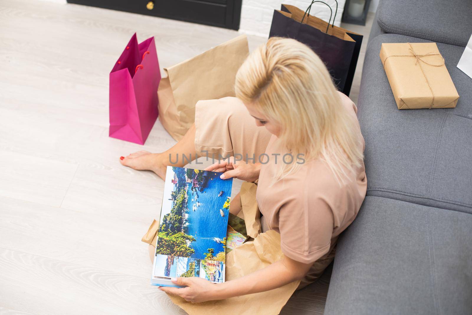 Woman Looking At Photo Album Or Photobook.