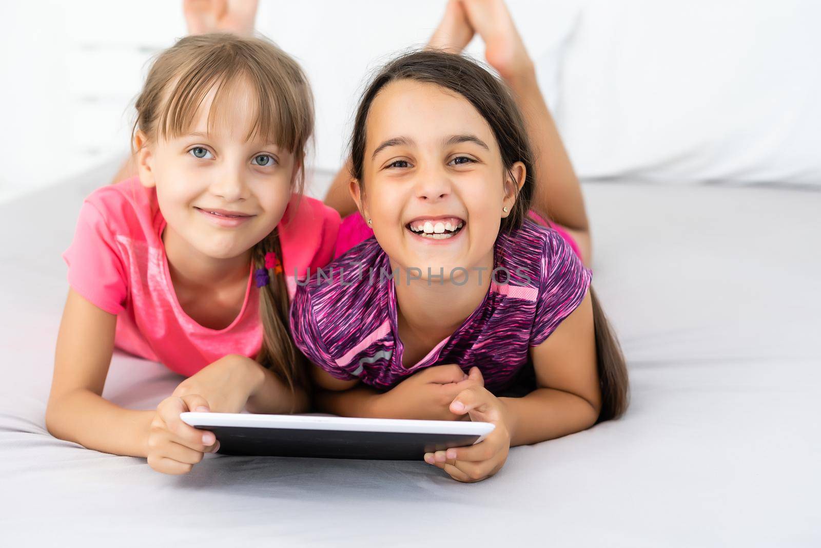 Little girls using tablet computer as art board - painting together by Andelov13