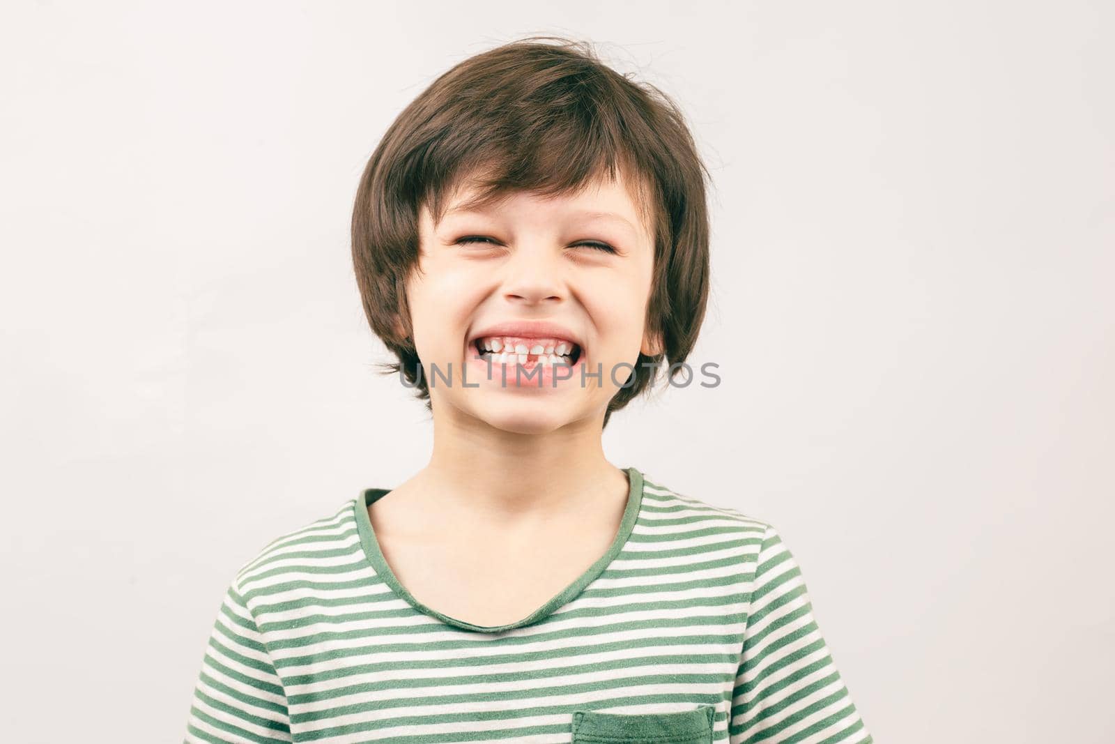 White 6 year old boy shows his smile without one tooth. Kids dental health concept