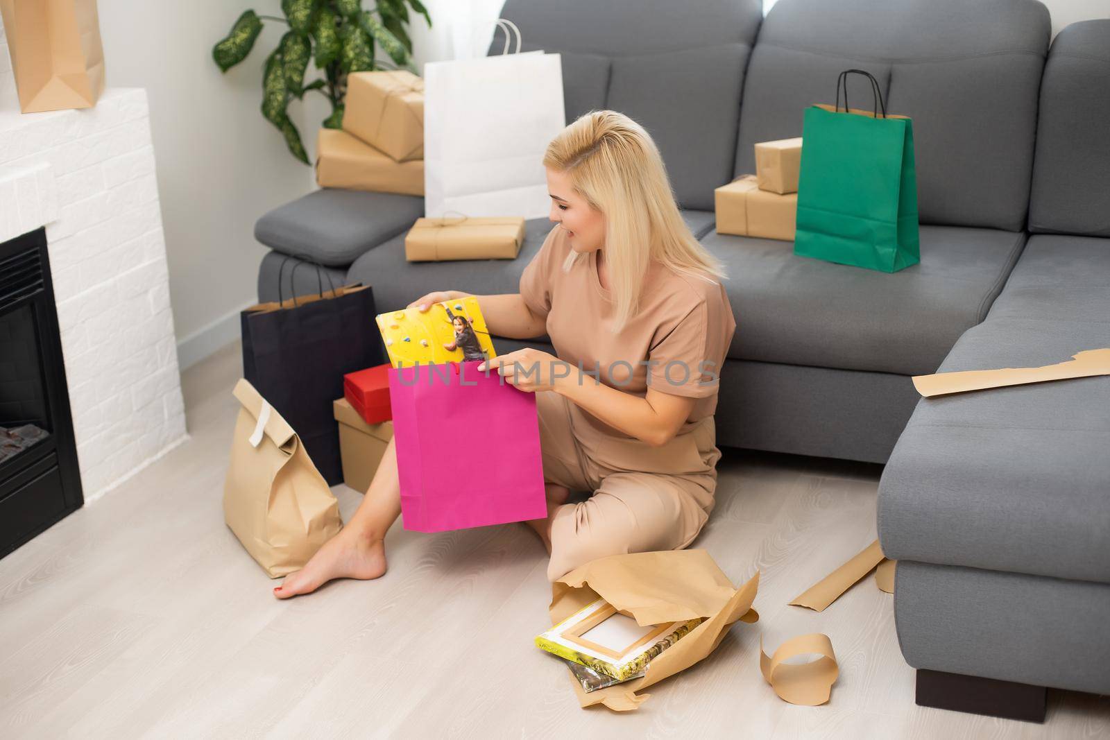 woman holding and unpacking photo canvas gifts.