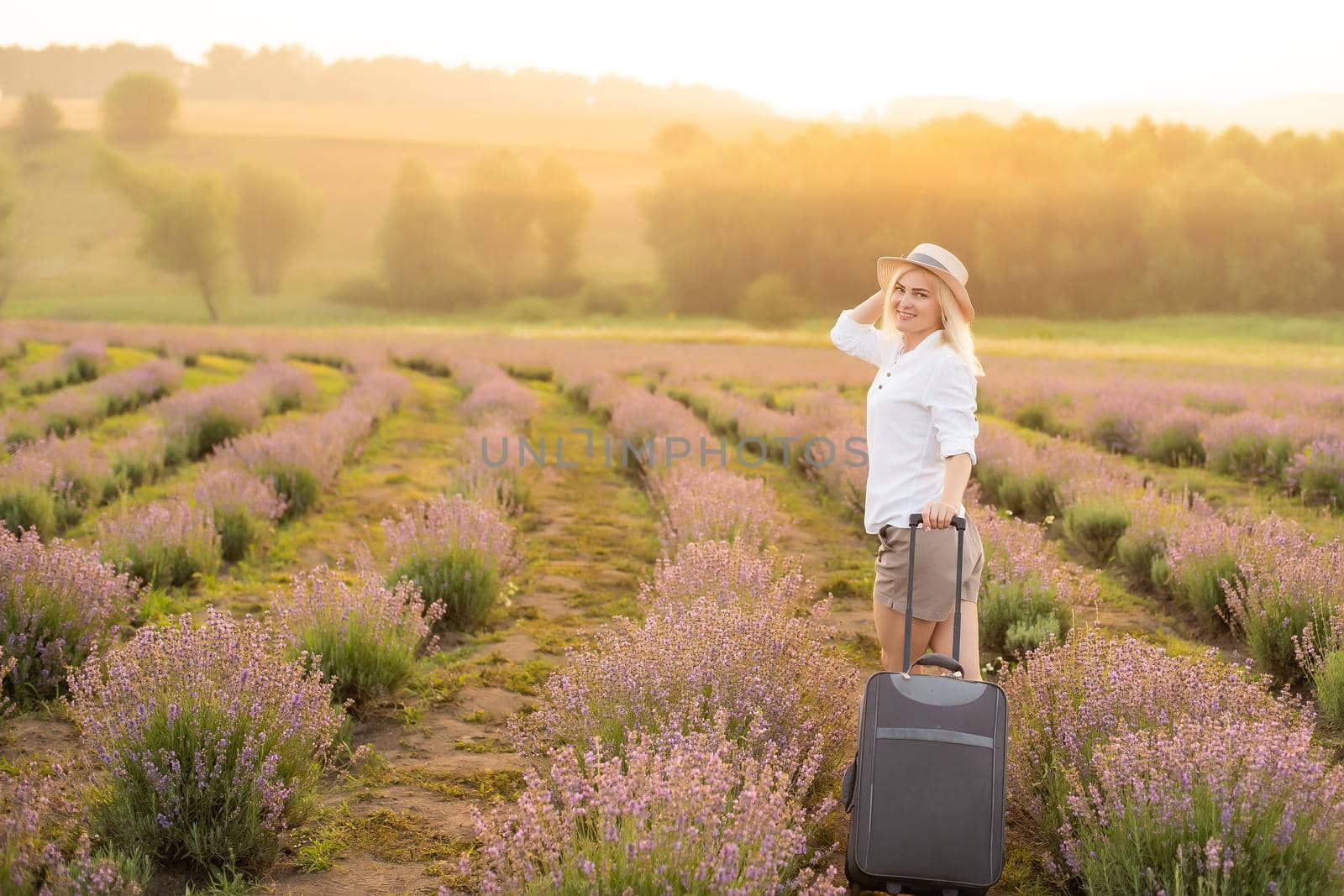 woman with suitcase in lavender field