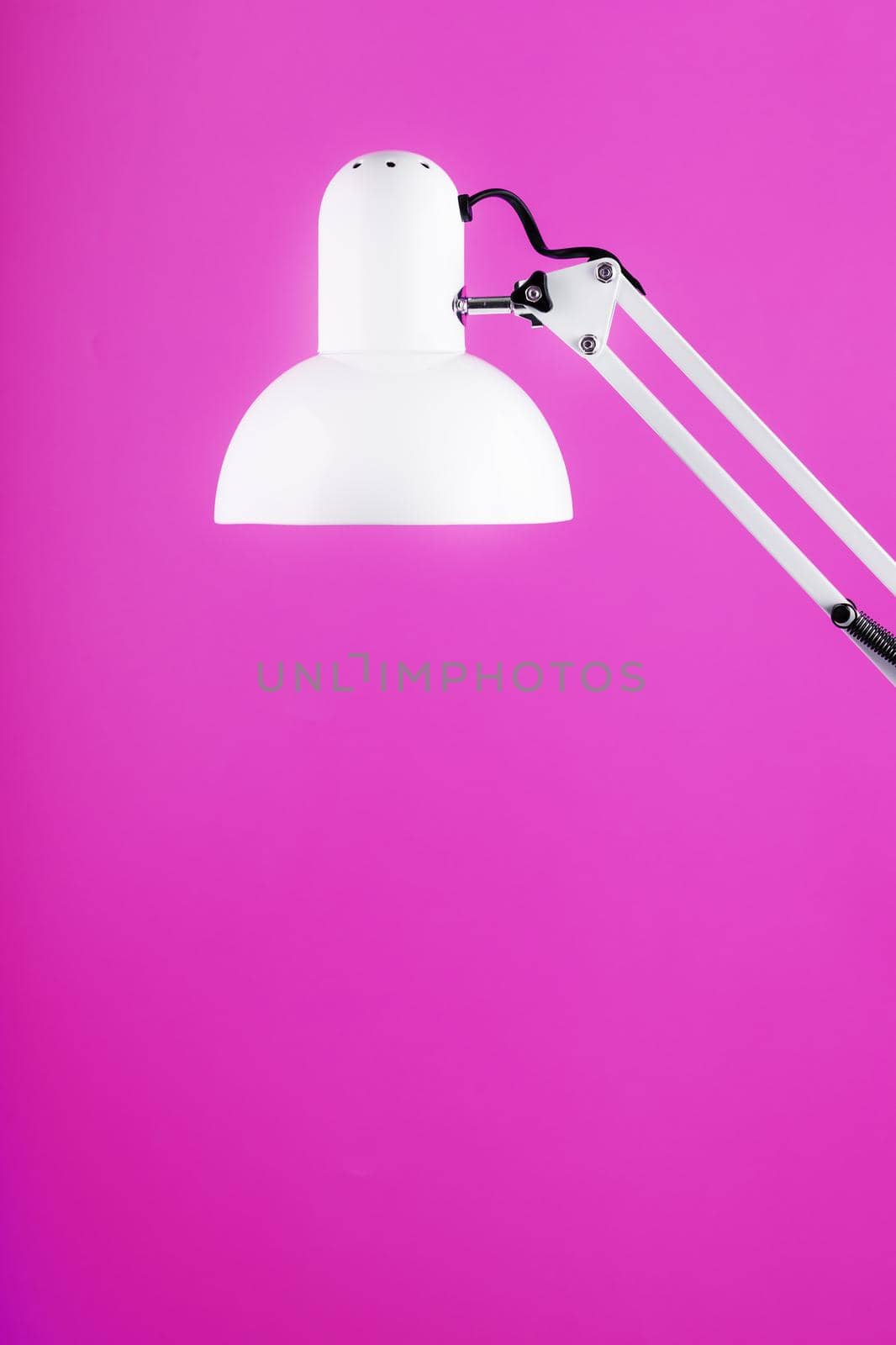 White table office lamp on pink background with space for text and idea concept by AlexGrec