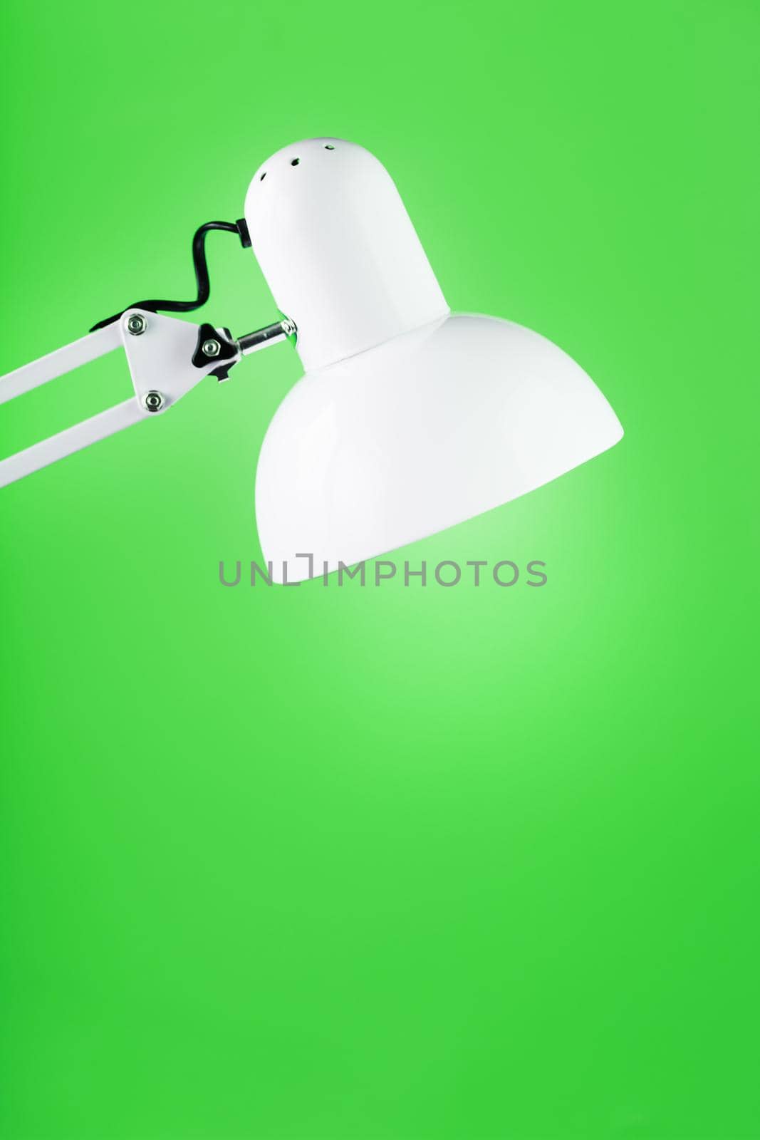 Office table lamp on green background with space for text and idea concept by AlexGrec