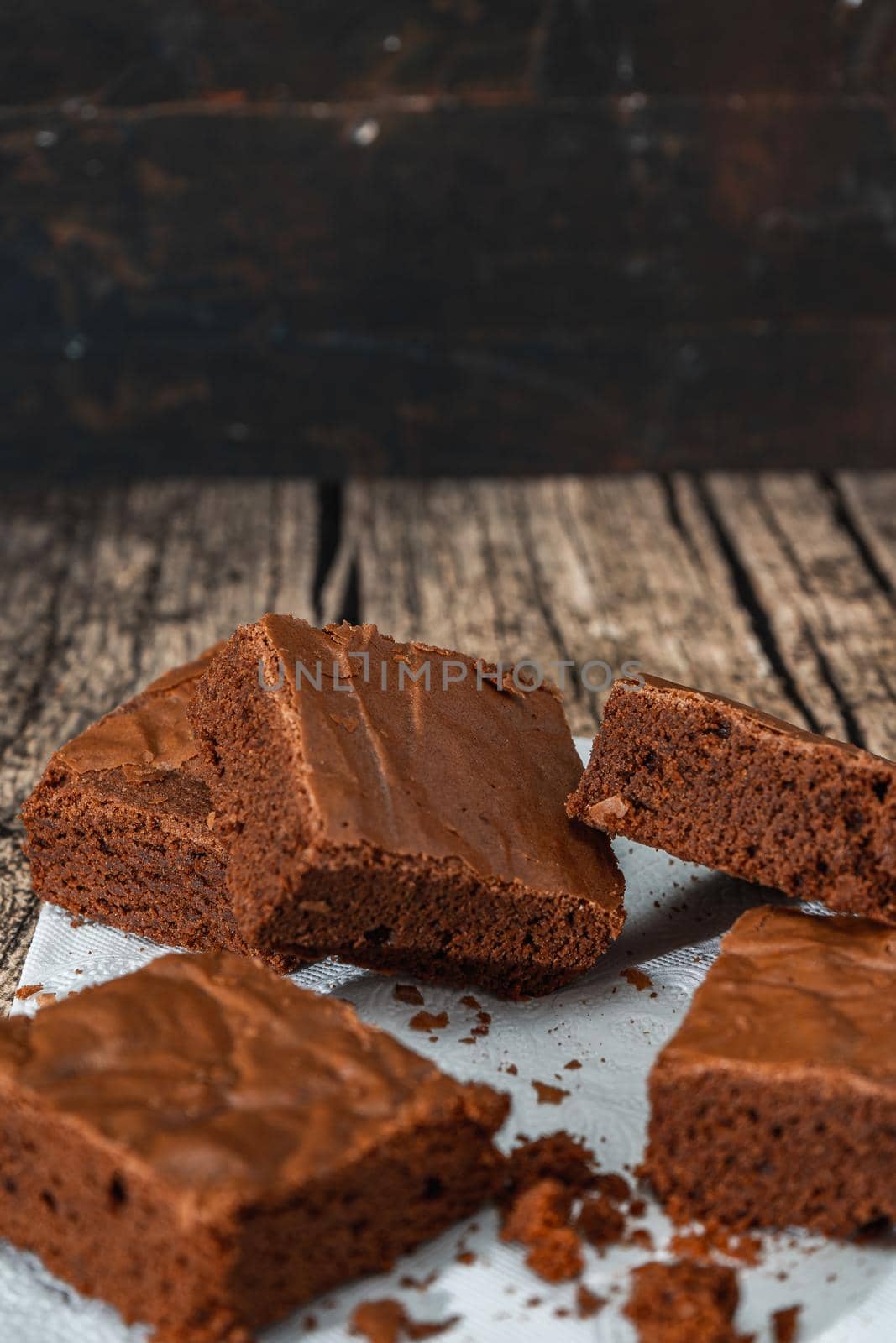 Homemade chocolate brownie squares on a table. Vertical orientation. Copy space. high view.