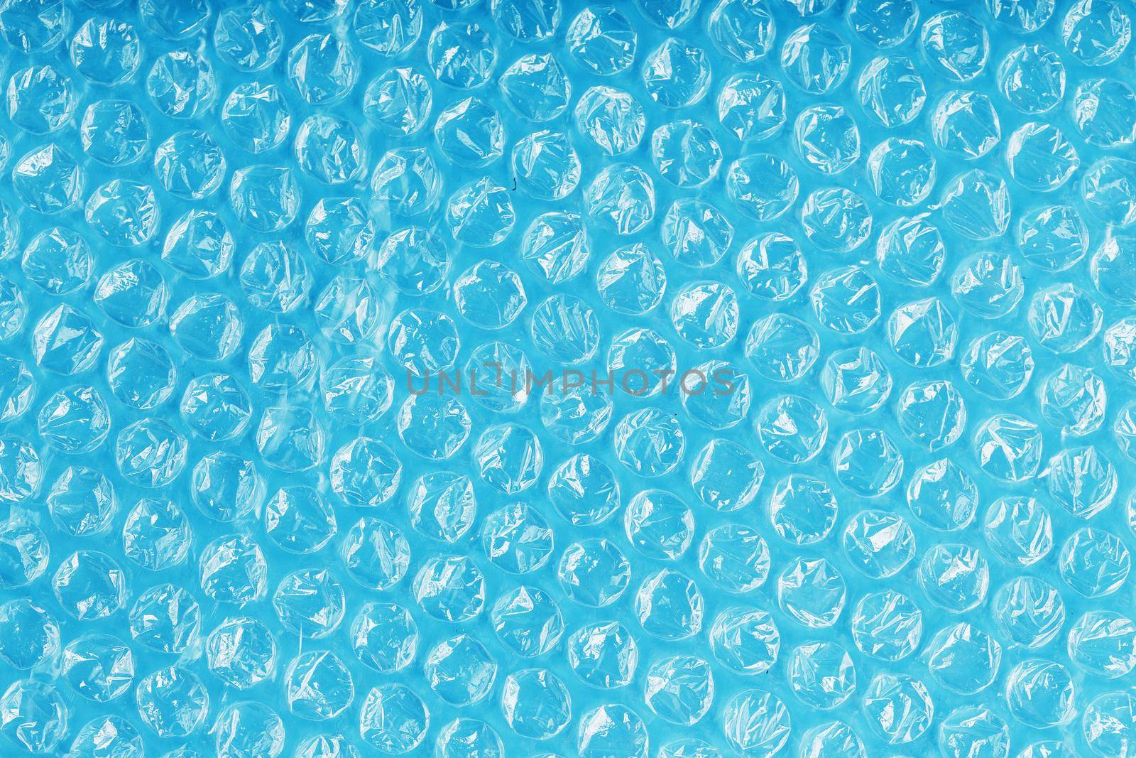 Packing bubble wrap for parcels on a blue background in full screen