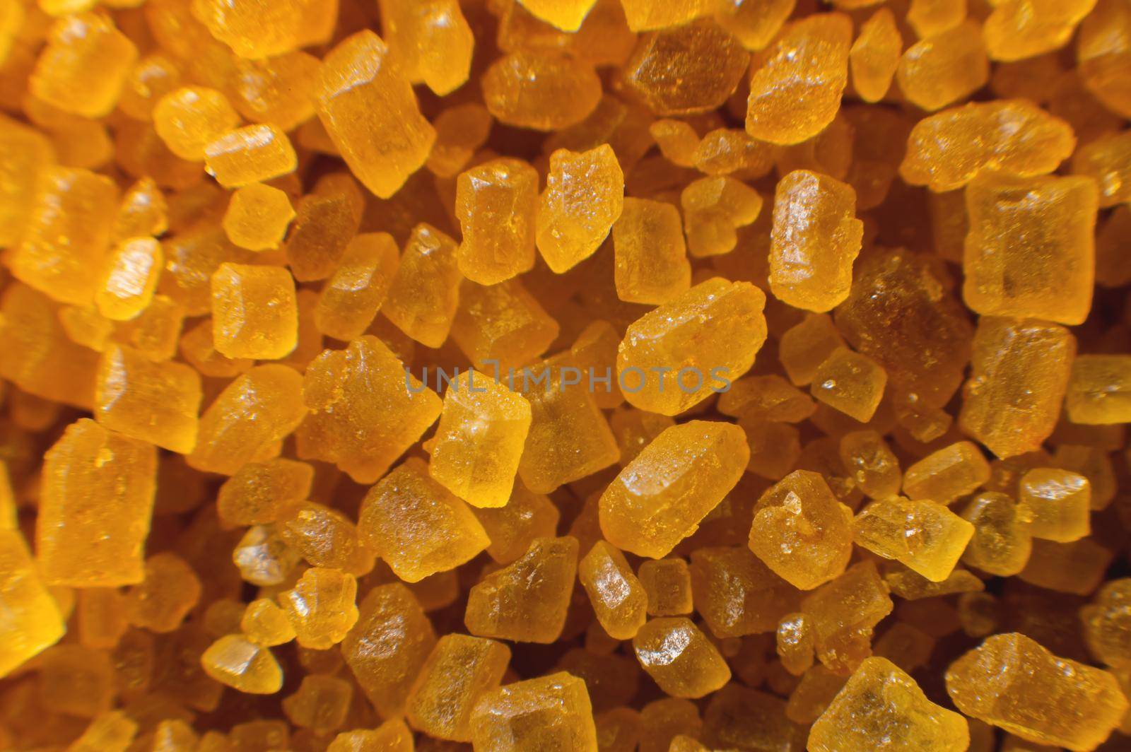 Extreme macro crystals of cane sugar. Abstract sugar background close-up in shallow depth of focus.