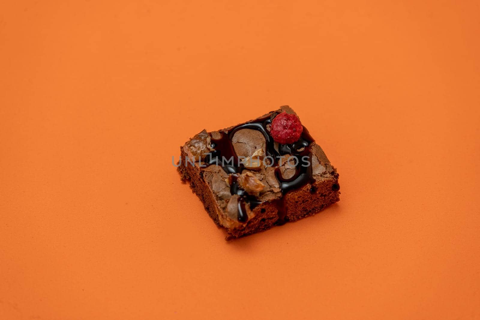 Chocolate brownie squares with walnut pieces, chocolate threads and granola. Natural, healthy food concept. High view. Copy space.