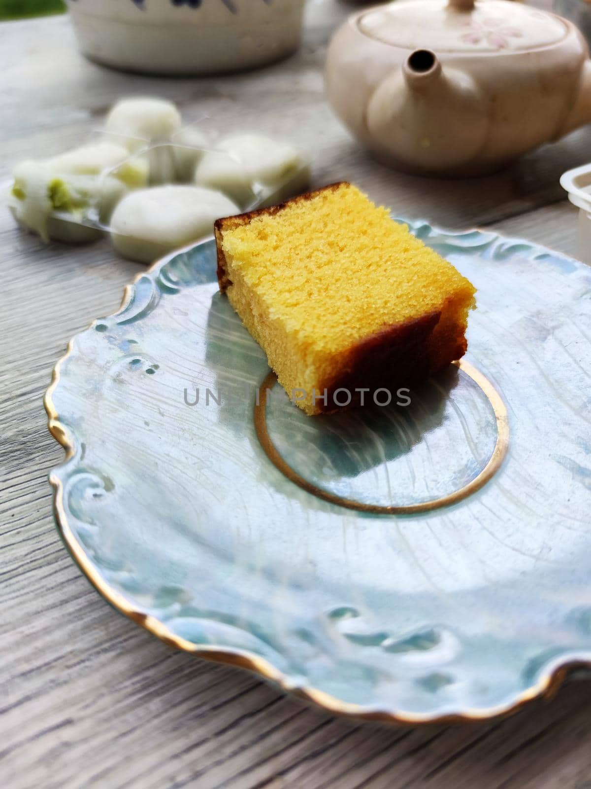 egg biscuit, japanese mochi dessert and teapot on the table by Annado