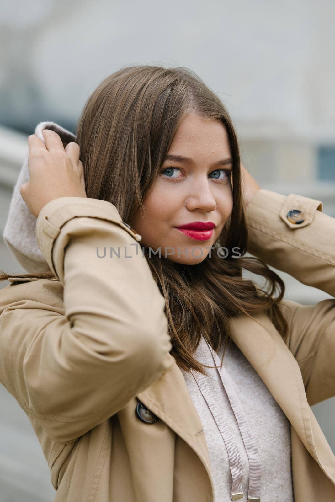 Portrait of fashionable women in beige sports suit and trench coat posing on the street by Ashtray25