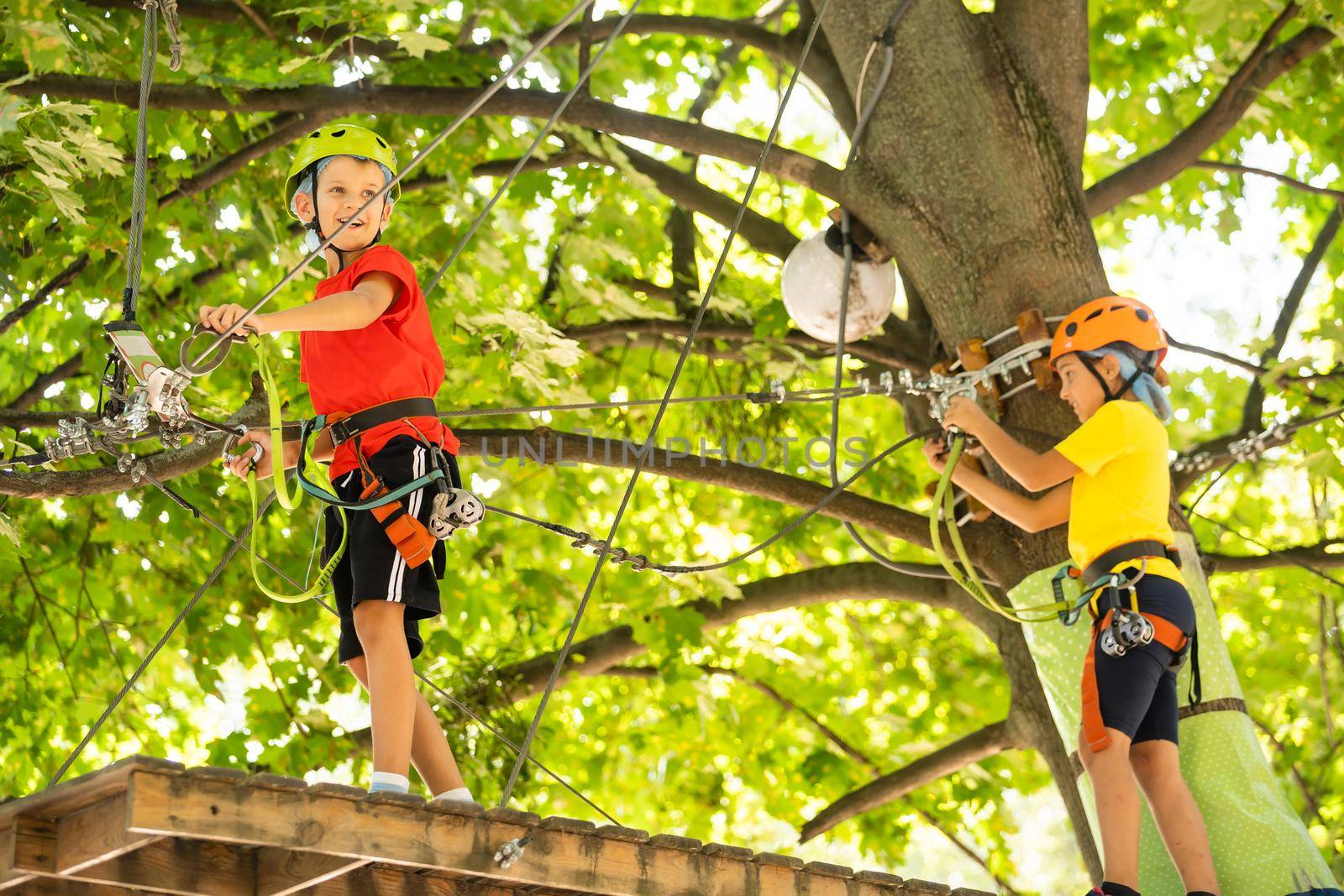 Boy climber walks on the rope bridge