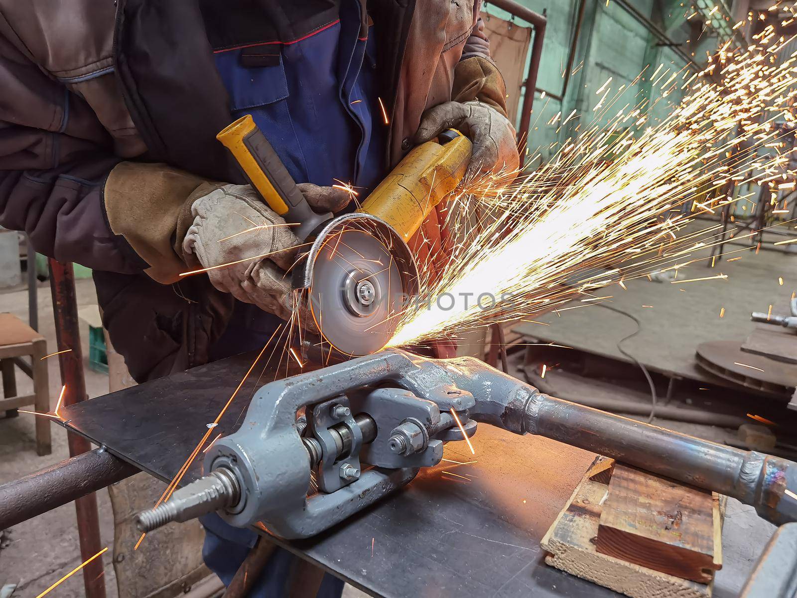 Grinding Work with Smooths Equipment for Steel Metal, Iron, Sparks at Manufacturing Heavy Industry Factory Close Up Indoor. by EdVal