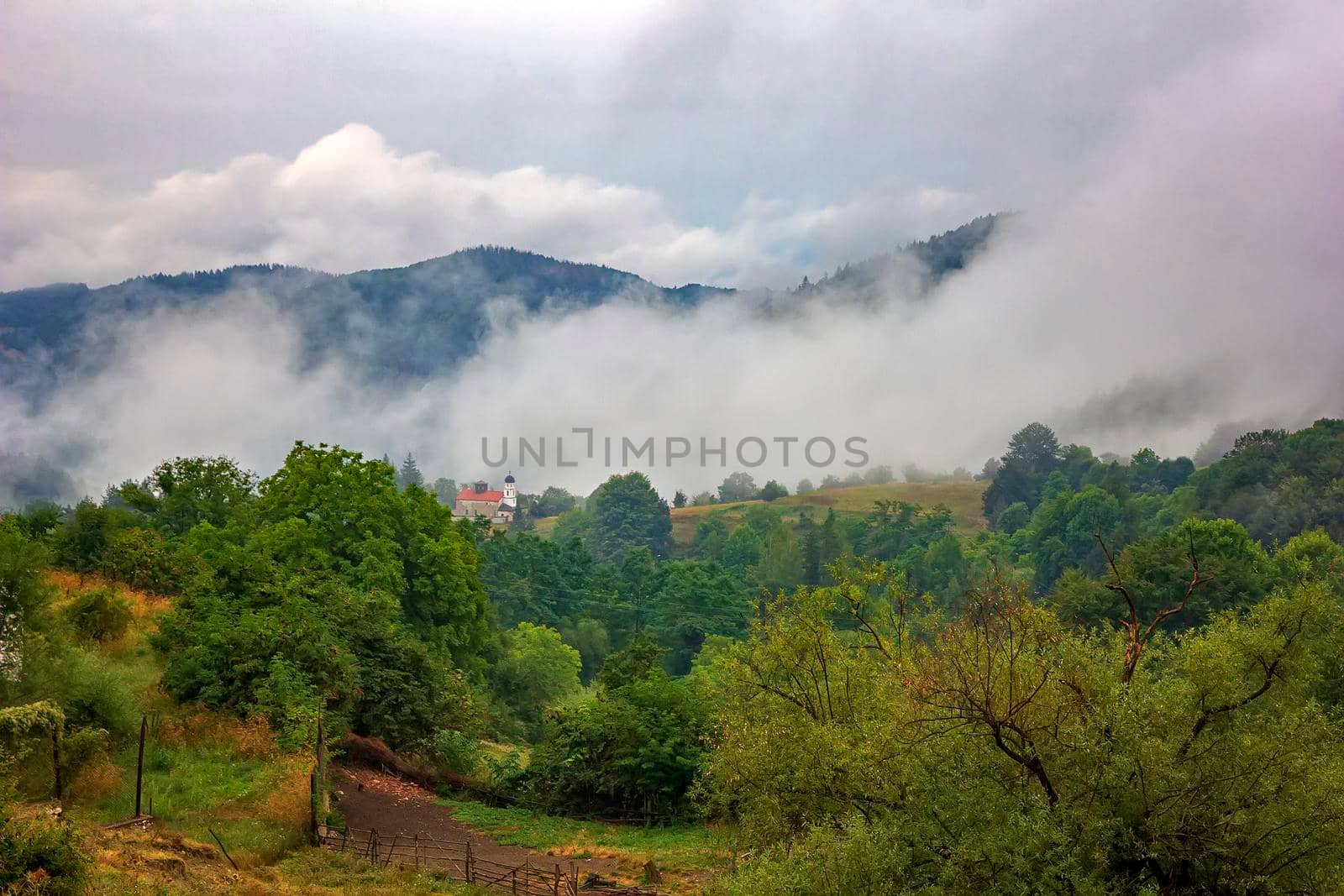 beauty mountain landscape with alone building and mist over the mountain by EdVal