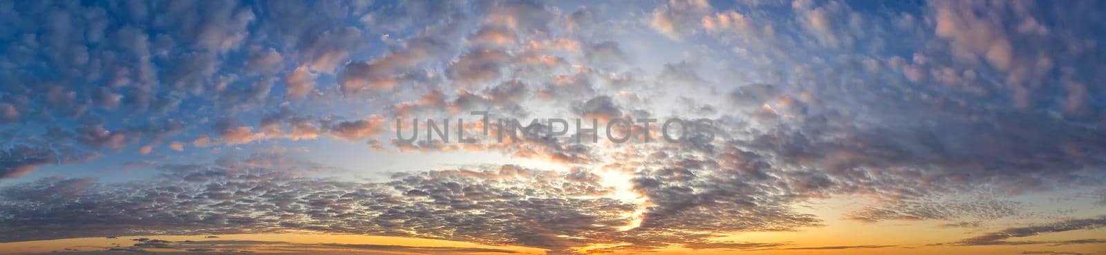 Dramatic clouds at sky at sunset .