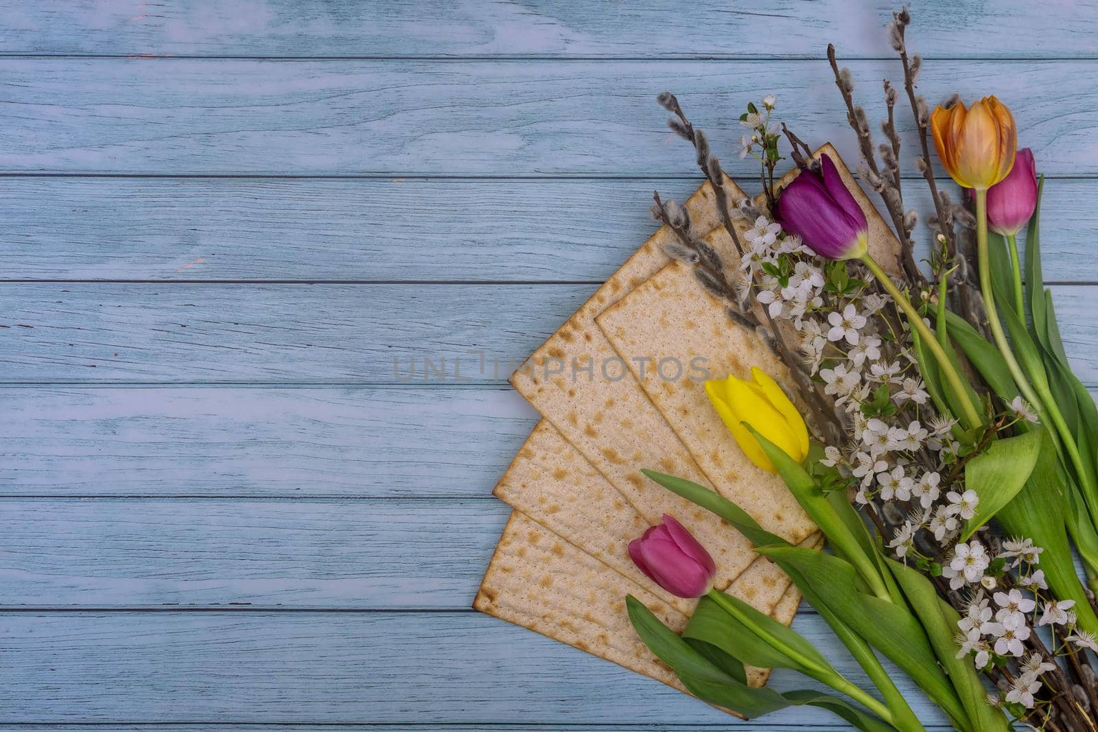 Jewish Passover holiday Pesach celebration with flowers matzah unleavened bread,
