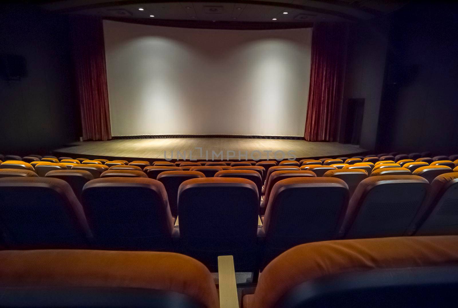 Empty chairs in the stands of the movie theater. Many empty seats for spectators. 