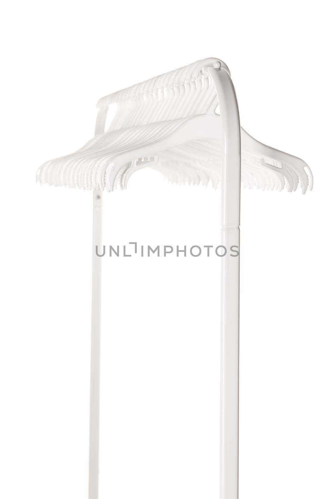 White plastic hangers for clothes hanging on rod from clothing rack. Isolated on white background.. by kokimk