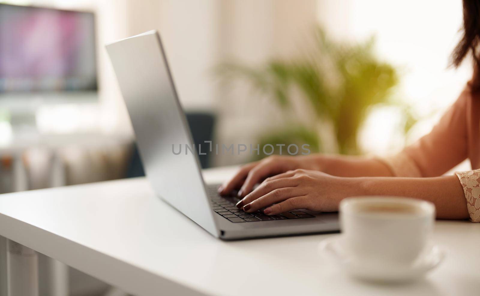 Close up asian woman using laptop computer at home by nateemee