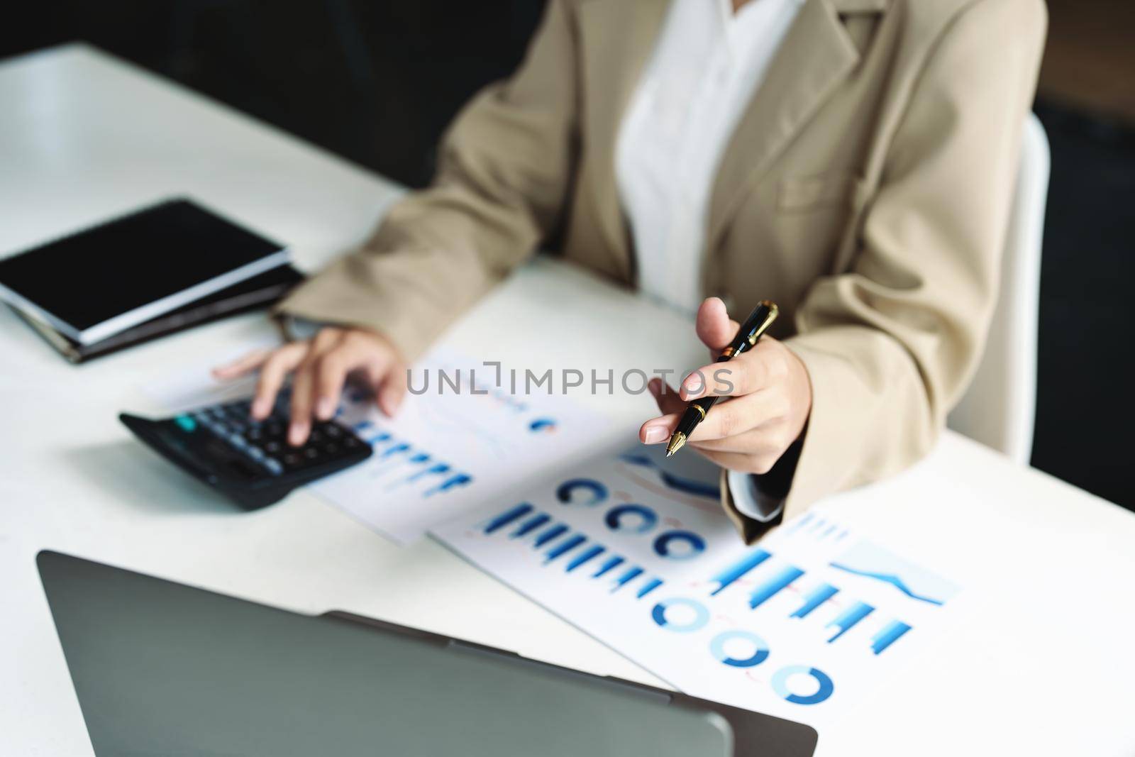 Data analysis, roadmap, marketing, accounting, auditing. Asian business woman holding pen and using computer in video conferencing, presenting marketing plan using statistical data sheet at work. by Manastrong