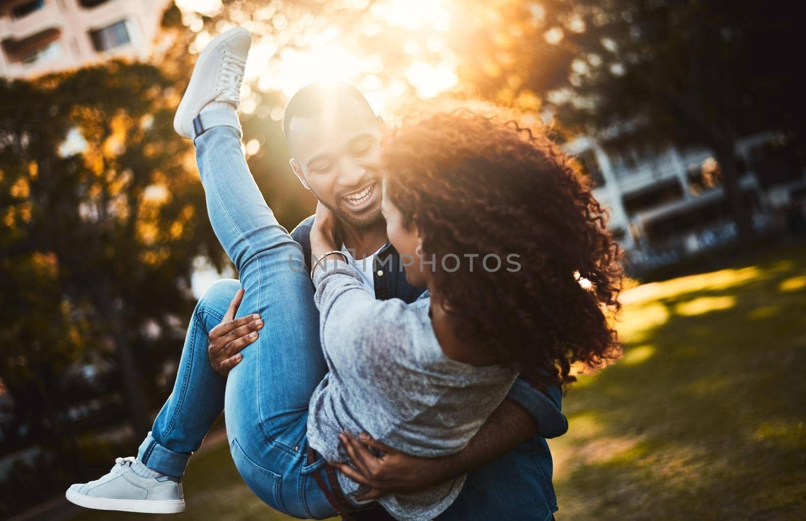 All their days are fun together. Shot of a young couple having fun together outdoors. by YuriArcurs