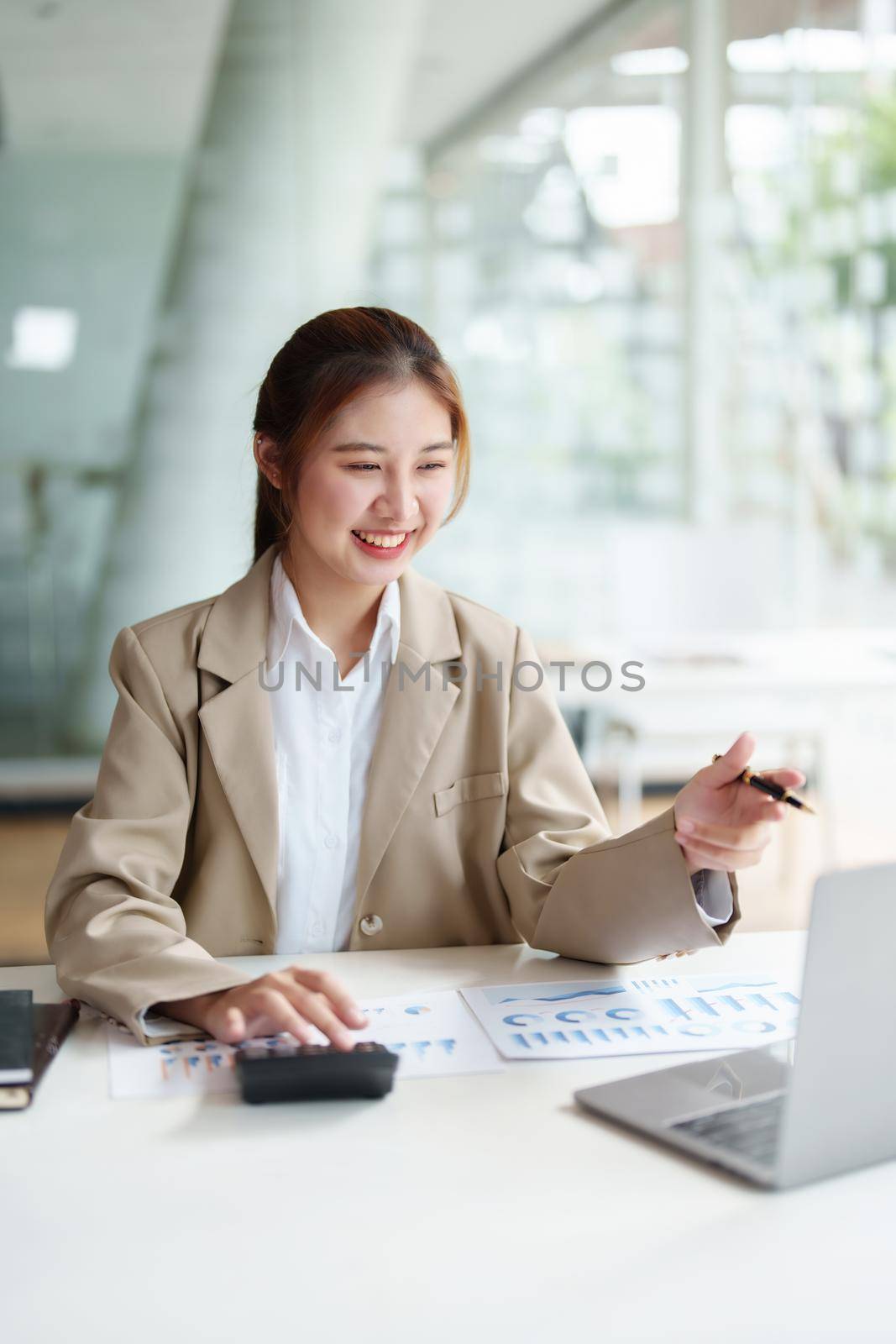 Data analysis, roadmap, marketing, accounting, auditing. Portrait of Asian businesswoman using computer in video conferencing, presenting marketing plan using statistical data sheet at work. by Manastrong