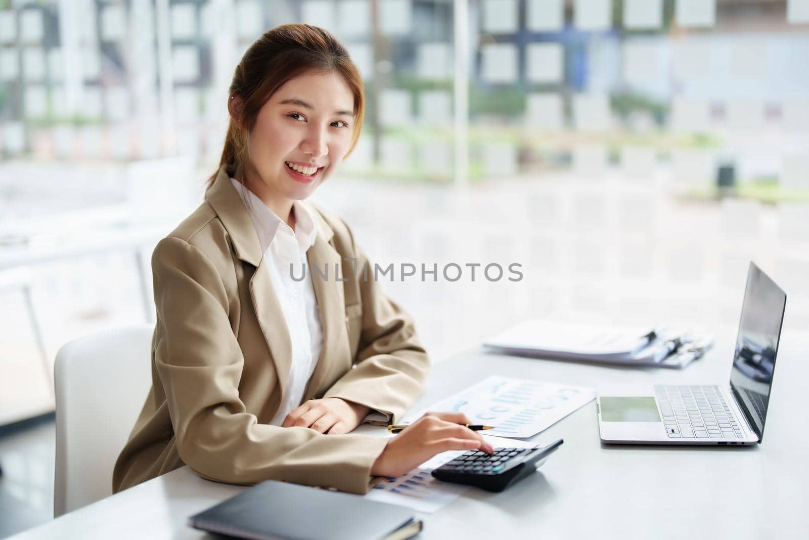 accountant, Auditor, Self-Employed, Finance and Investment, tax calculation and budget, Portrait of Asian female entrepreneur using a calculator to calculate. Company business results document. by Manastrong