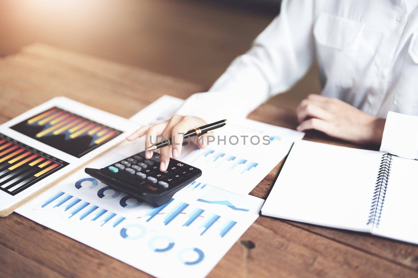 accountant, Auditor, Self-Employed, Finance and Investment, tax calculation and budget, Asian female entrepreneur using a calculator to calculate. Company business results document. by Manastrong