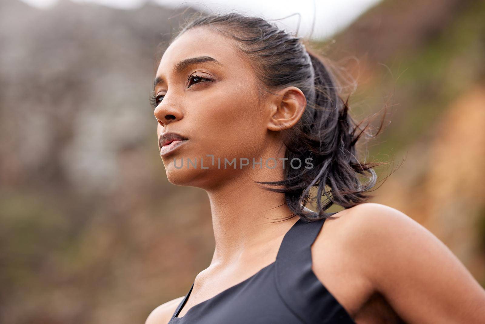 You can do it out your MIND into it. Shot of a fit young woman catching her breathe while completing her jog outdoors. by YuriArcurs