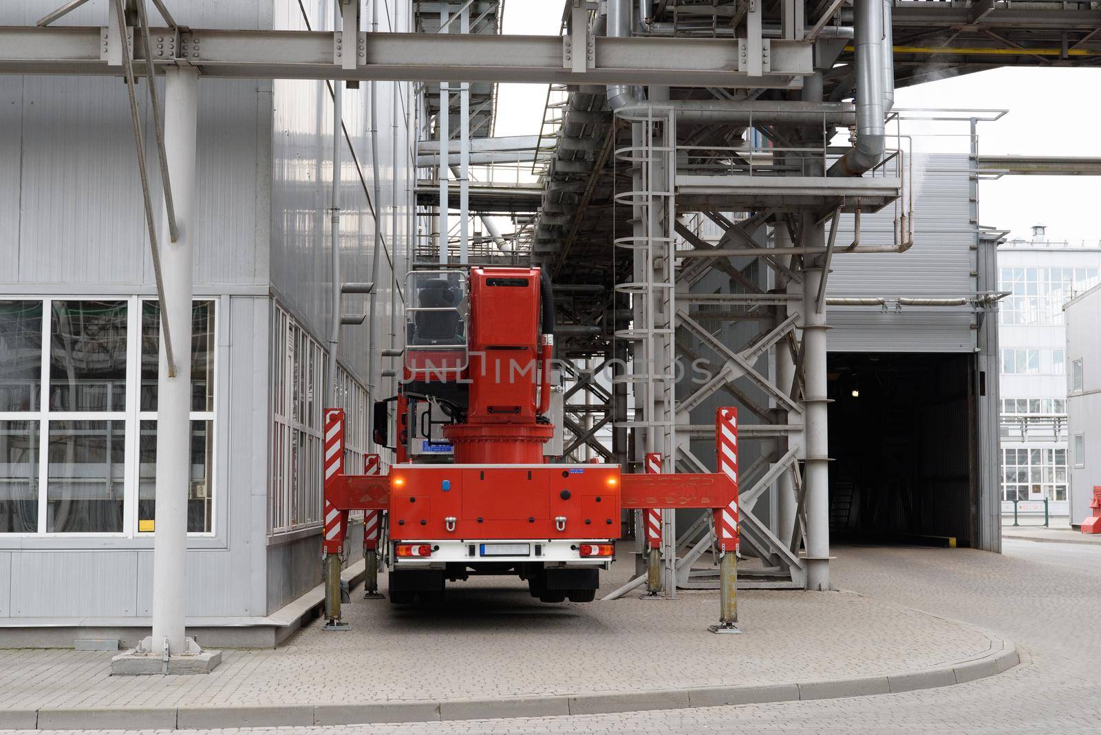 fire truck on the territory of the plant. metal buildings of the sunflower oil plant.