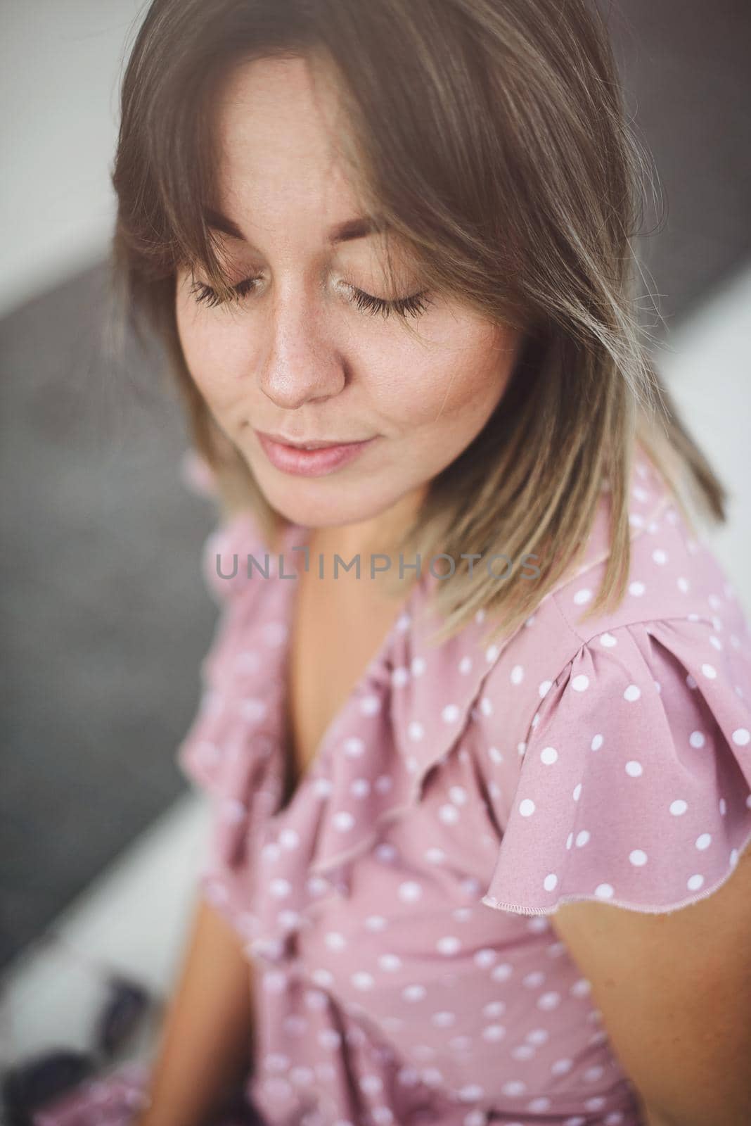 young beautiful brunette posing on the street in a soft pink sundress by Ashtray25