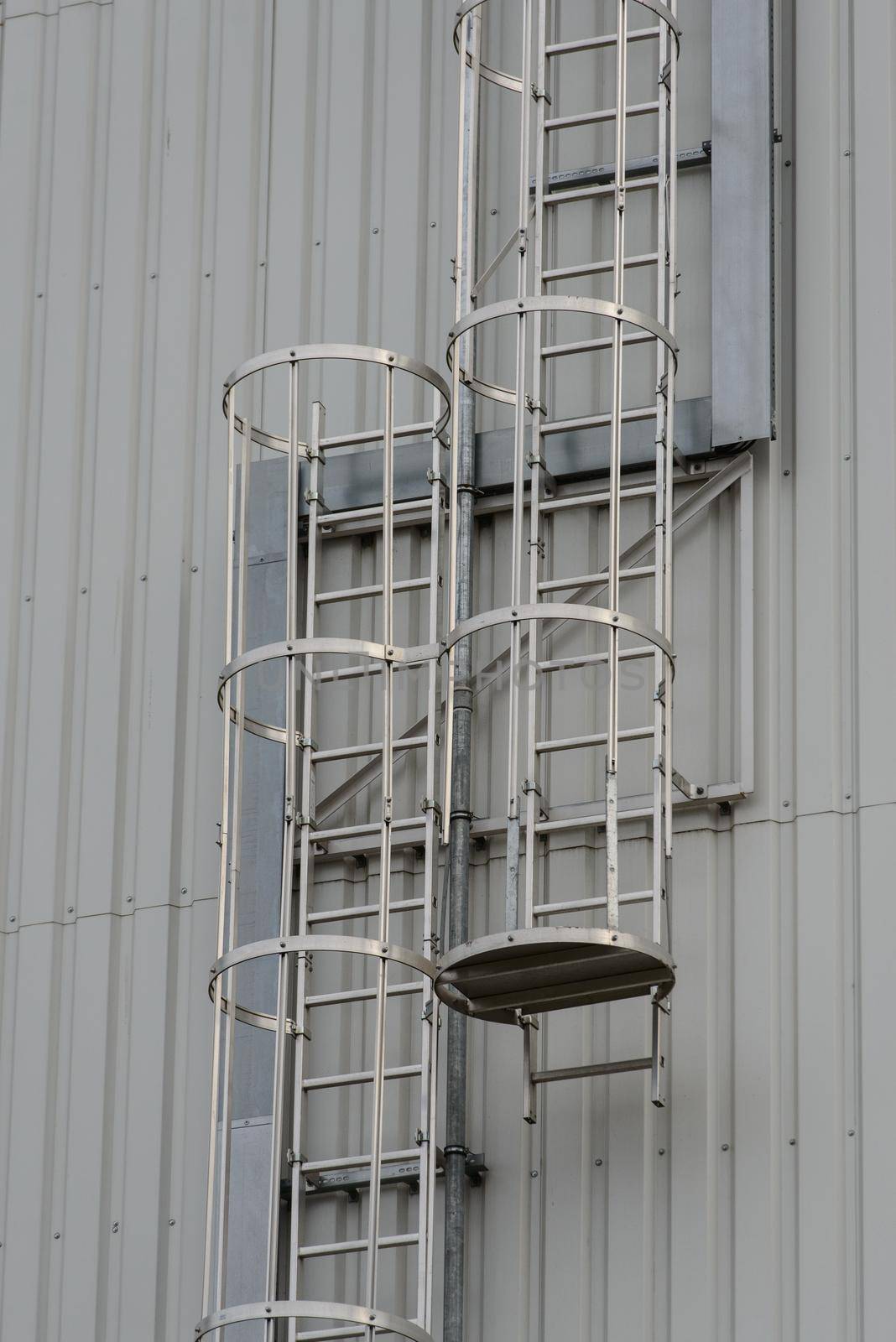 Iron staircase for up to maintenance work. Steel stairs are on the side of the building walls.