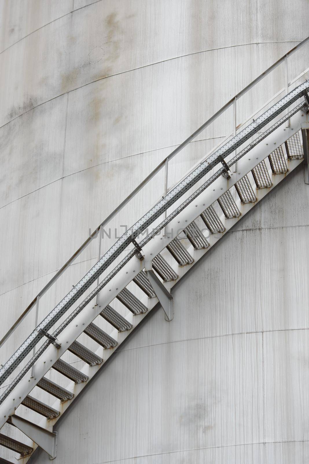 Iron staircase for up to maintenance work. Steel stairs are on the side of the building walls.