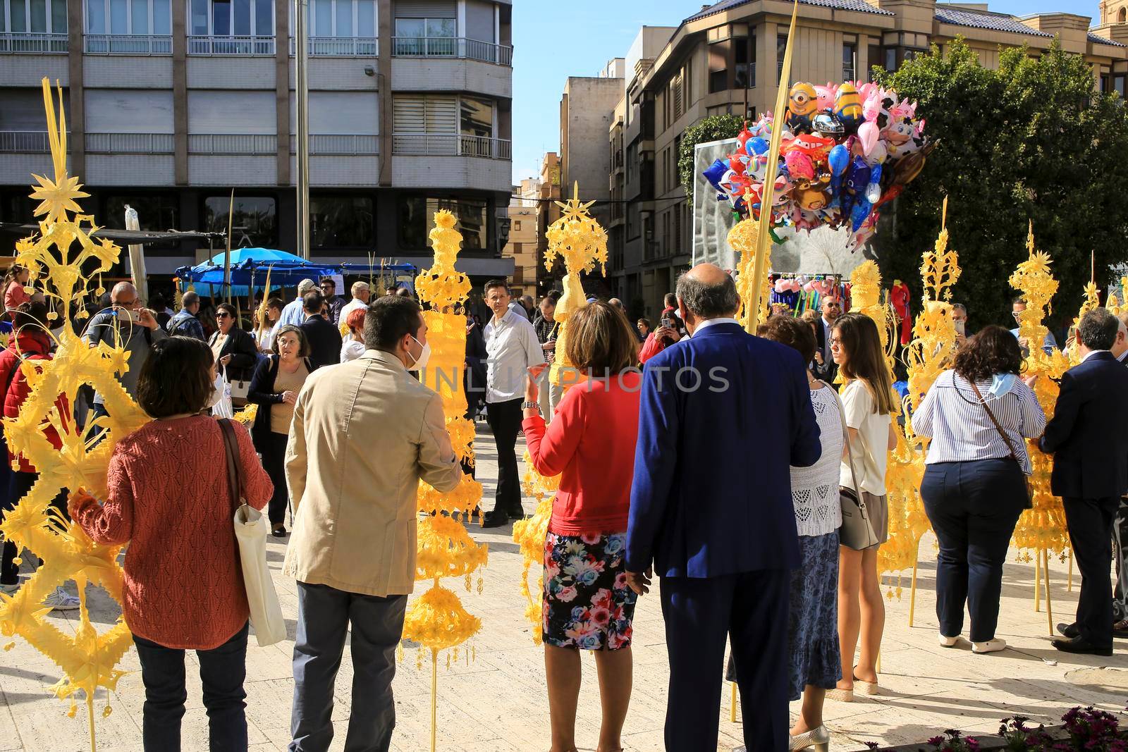 Elche, Alicante, Spain- April 10, 2022: People with award winning white palms for the Palm Sunday of the Holy Week of Elche