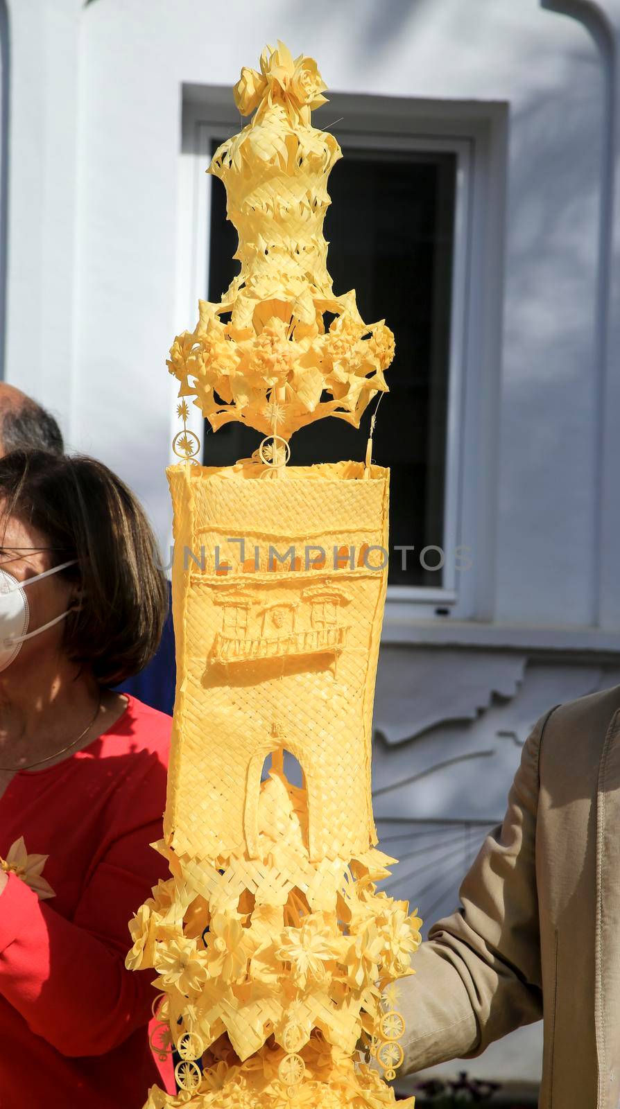 Elche, Alicante, Spain- April 10, 2022: People with award winning white palms for the Palm Sunday of the Holy Week of Elche