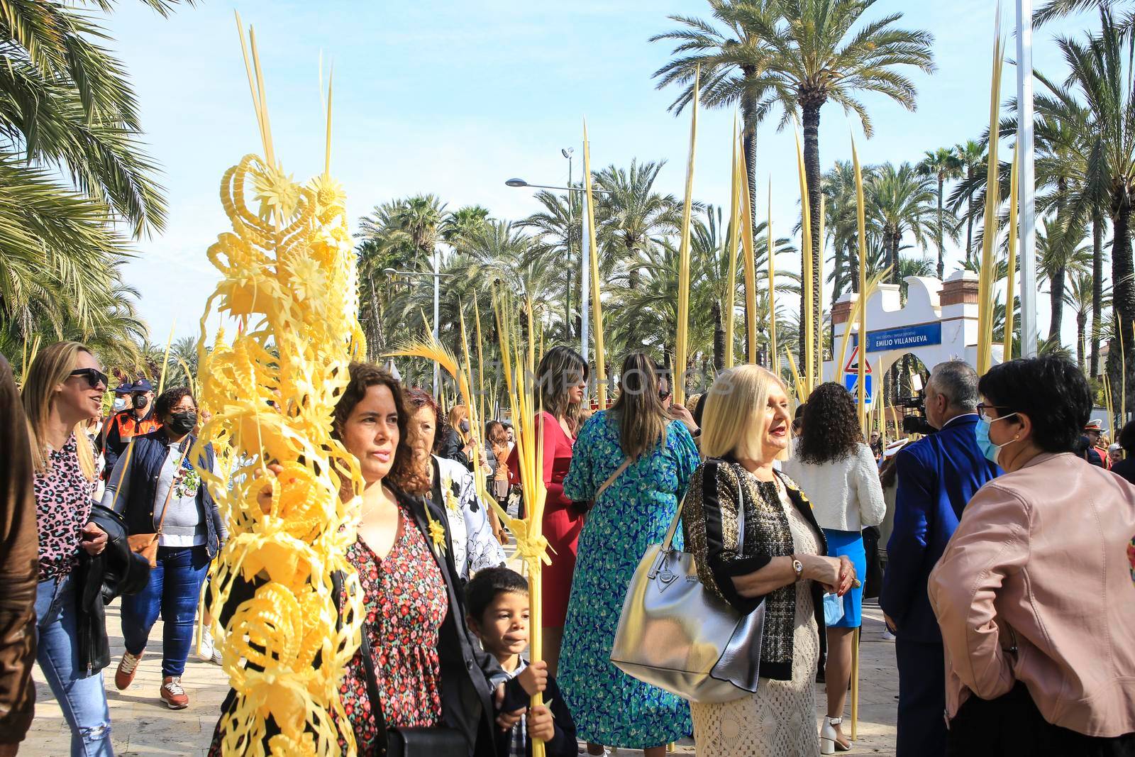 Elche, Alicante, Spain- April 10, 2022: People with white palms for the Palm Sunday of the Holy Week of Elche