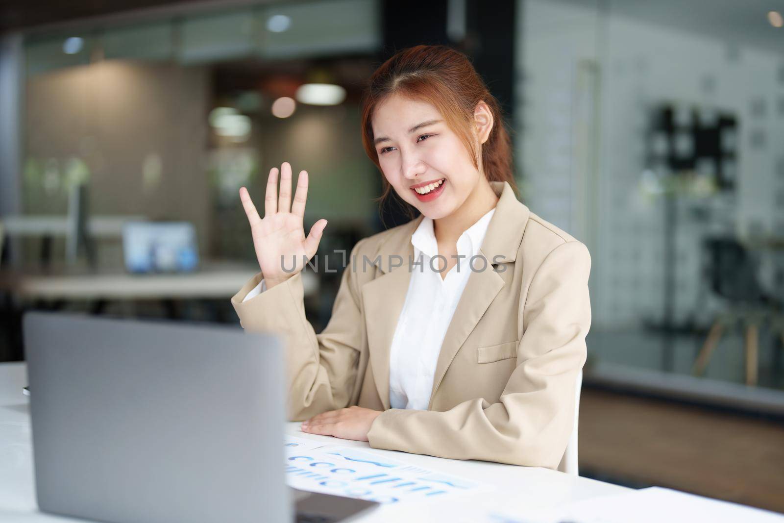 Data analysis, roadmap, marketing, accounting, auditing. Portrait of Asian businesswoman using computer in video conferencing, presenting marketing plan using statistical data sheet at work. by Manastrong