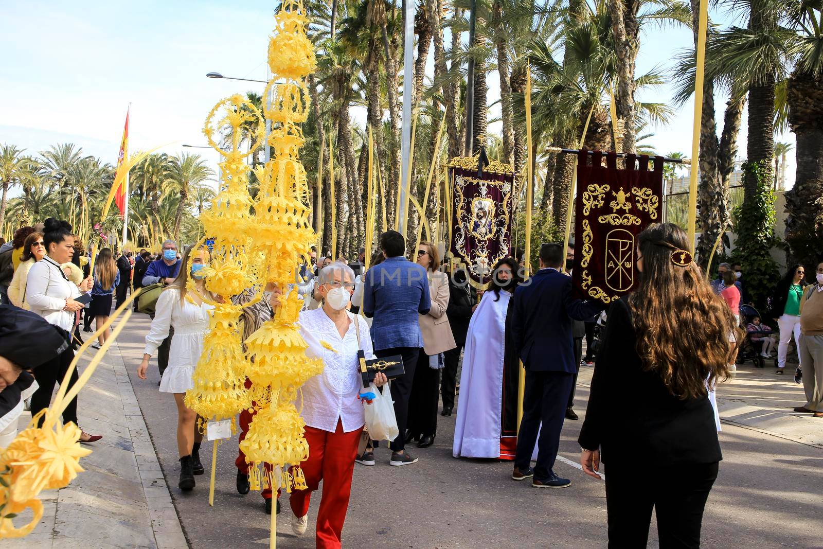 Elche, Alicante, Spain- April 10, 2022: People with white palms for the Palm Sunday of the Holy Week of Elche