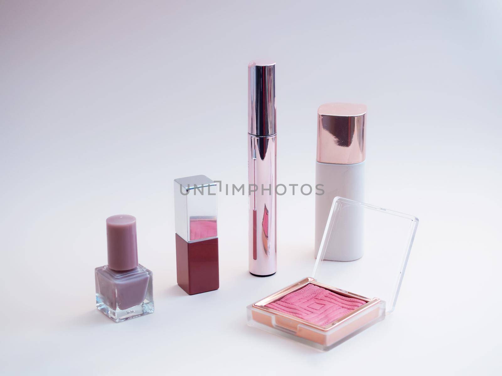set of beauty cosmetics for female face and eye makeup on pink background. by Andre1ns