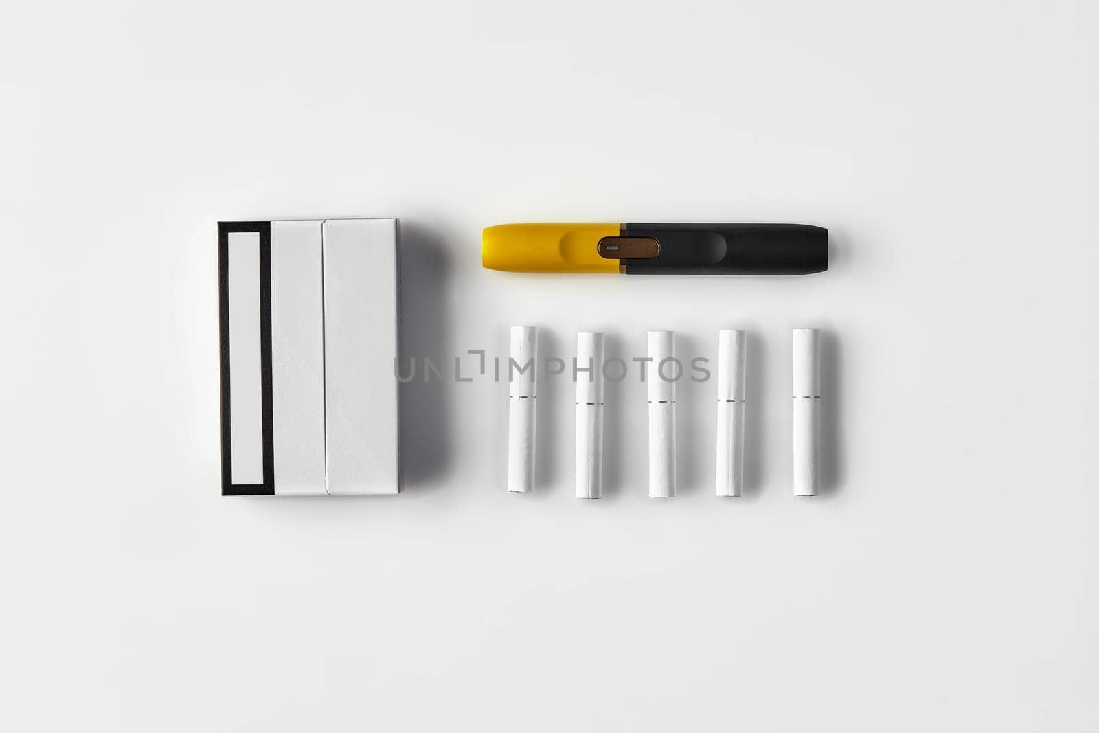 New generation black and yellow electronic cigarette, one pack and five heatsticks, isolated on white. New technology. Heating tobacco system. Template place for your text, image. Close up, flat lay