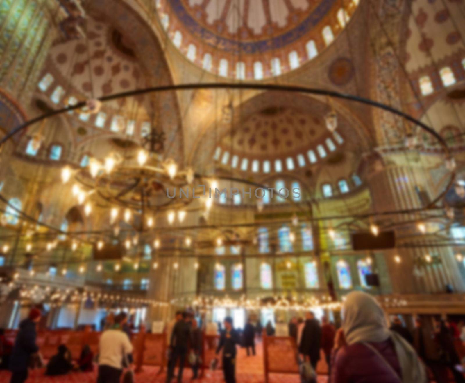 blur image of Muslims praying inside Mosque by sarymsakov