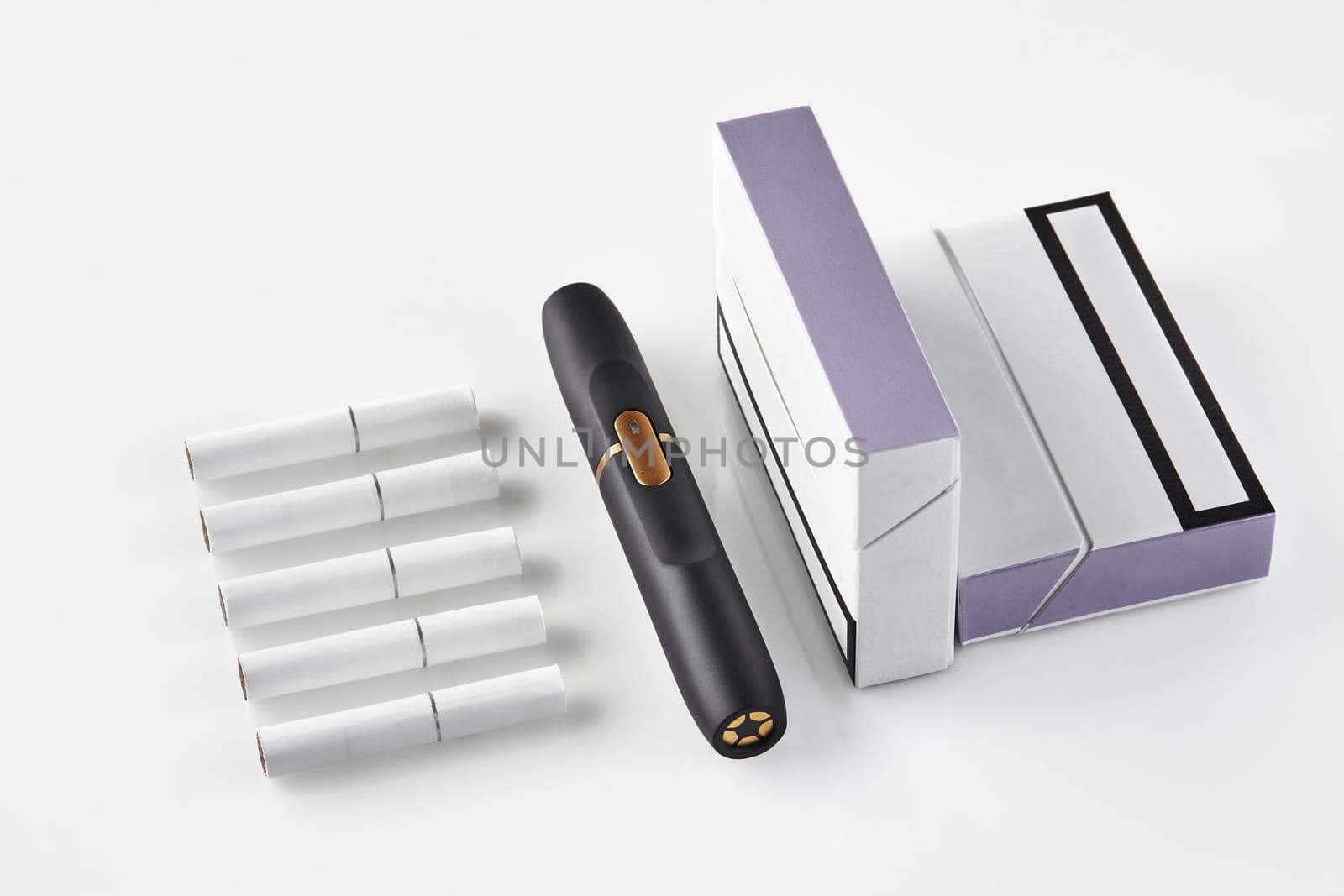 New generation black electronic cigarette, two packs with purple sides and five heatsticks isolated on white. Heating tobacco system. Close up by nazarovsergey