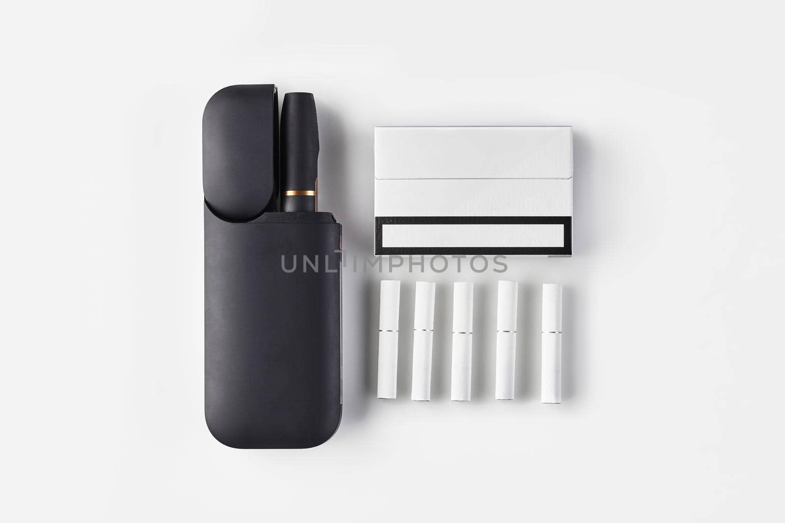 New generation black electronic cigarette in open battery, one pack, five heatsticks isolated on white. Hi-tech heating tobacco system. Close up by nazarovsergey