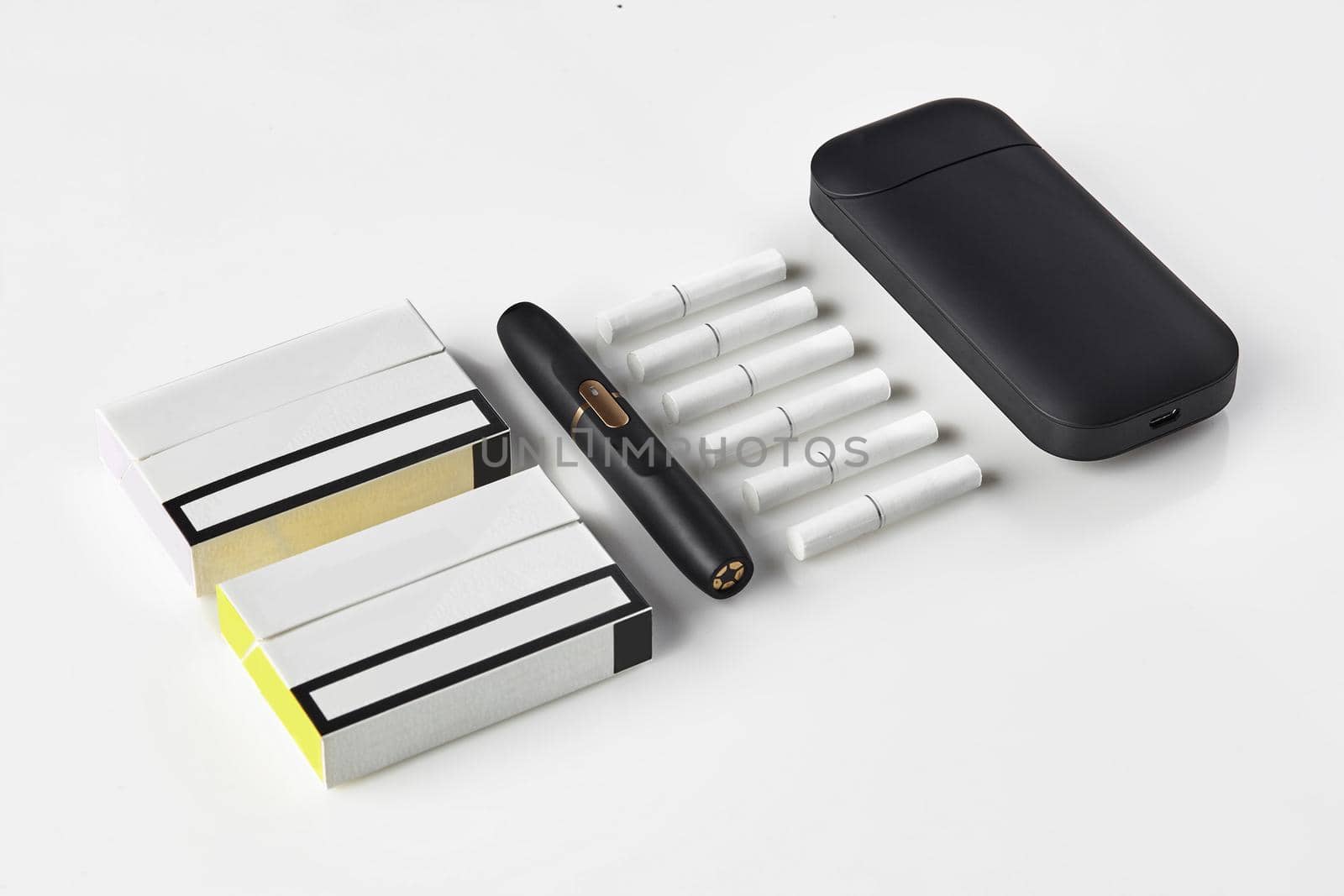 New generation black electronic cigarette and battery, two packs and six heatsticks isolated on white. New alternative technology. Heating tobacco system. Advertising area, workspace mock up. Close up