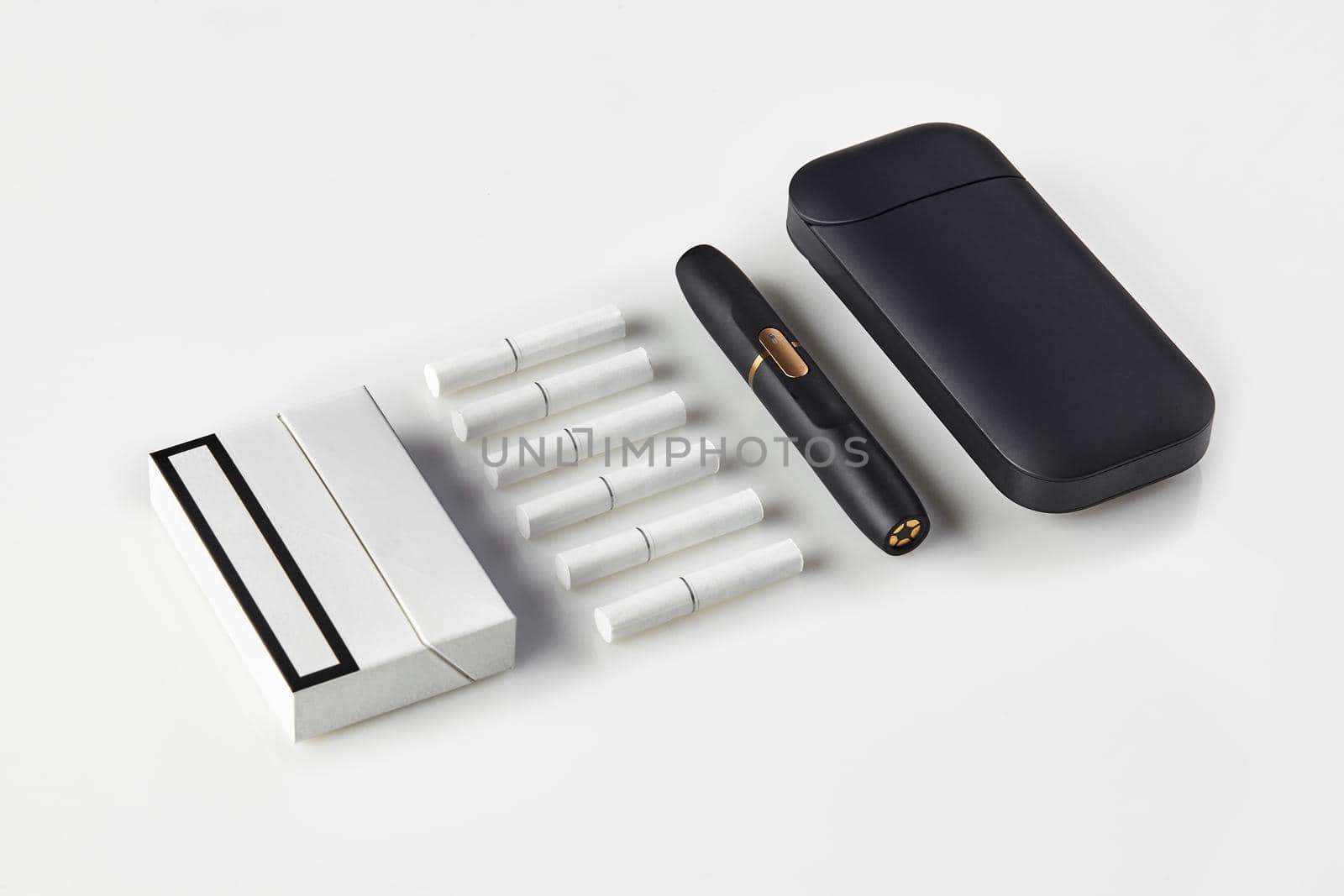 New generation black electronic cigarette and battery, one pack and six heatsticks isolated on white. Heating tobacco system. Tools used to help stop smoking. Template place for your text. Close up