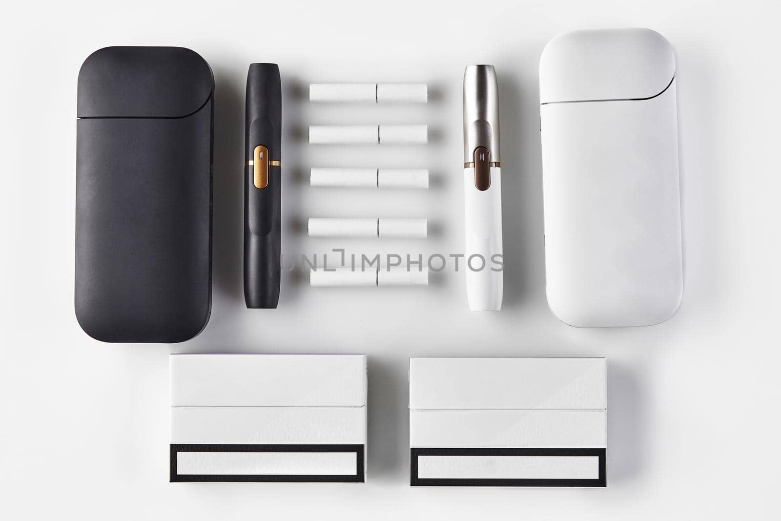 New generation, black and white two electronic cigarettes and batteries, five heatsticks, packs isolated on white. New alternative technology. Heating tobacco system. Close up, copy space, flat lay