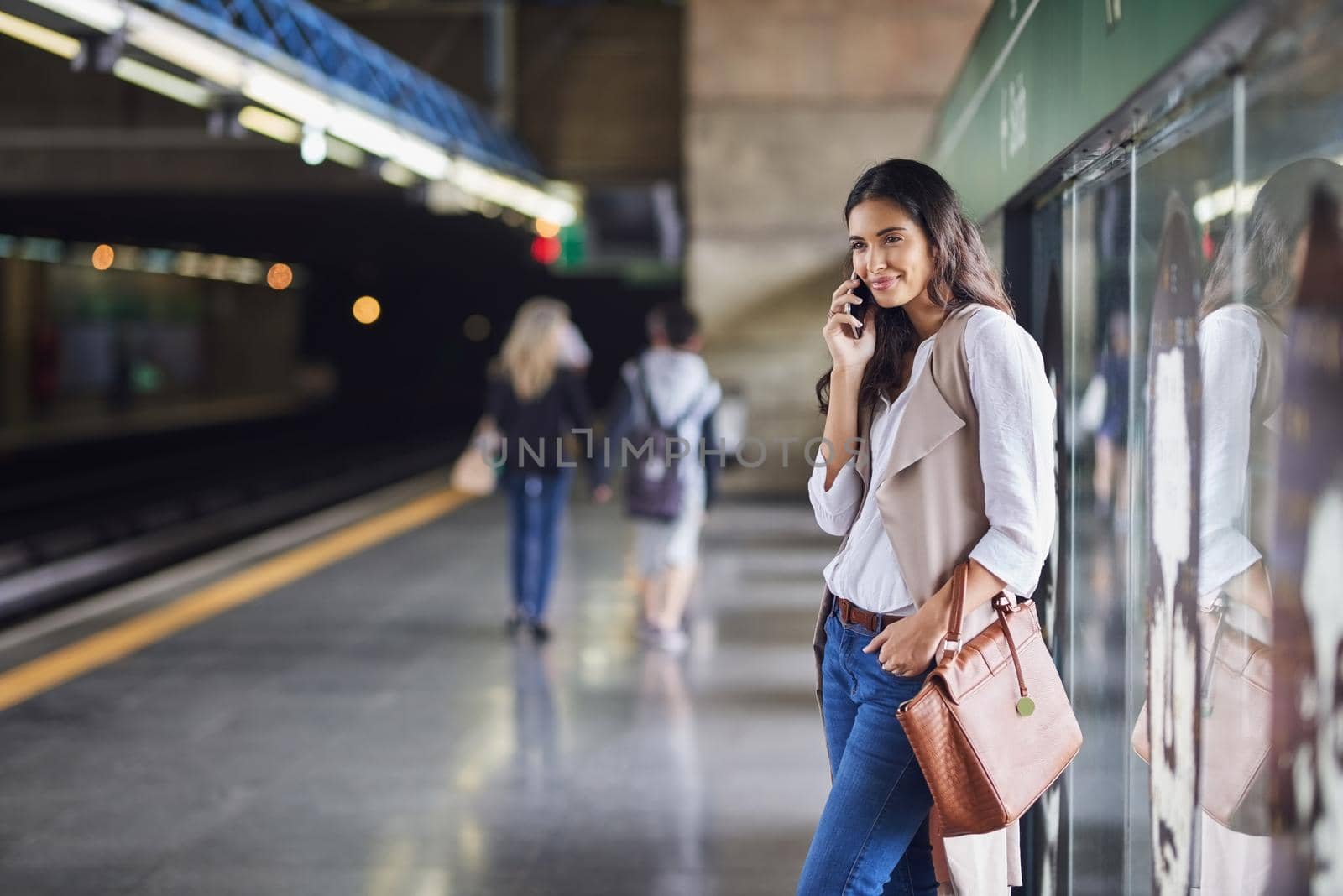 Cropped shot of a young attractive woman on a call and using the train to commute.