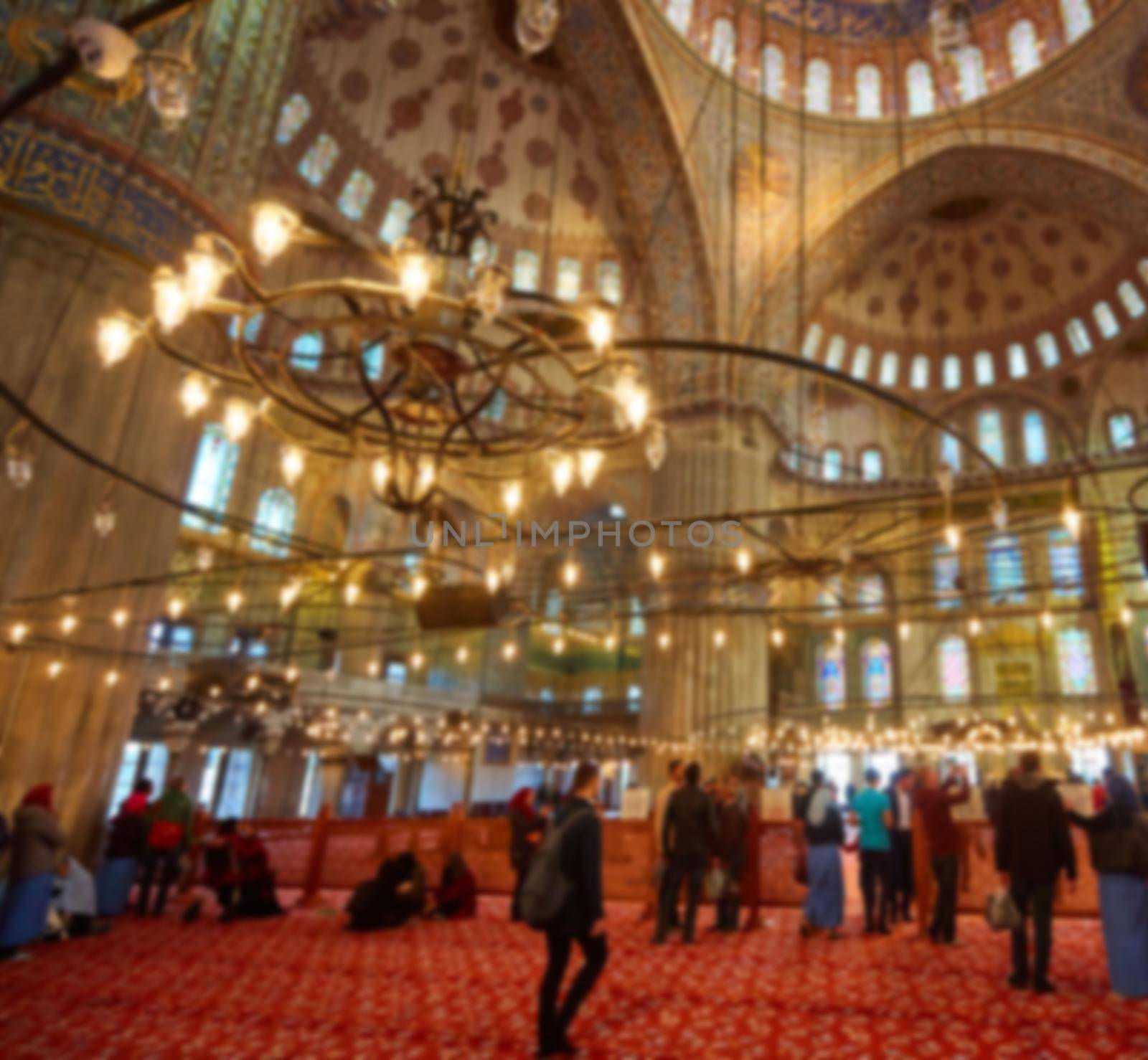 blur image of Muslims praying inside Mosque.
