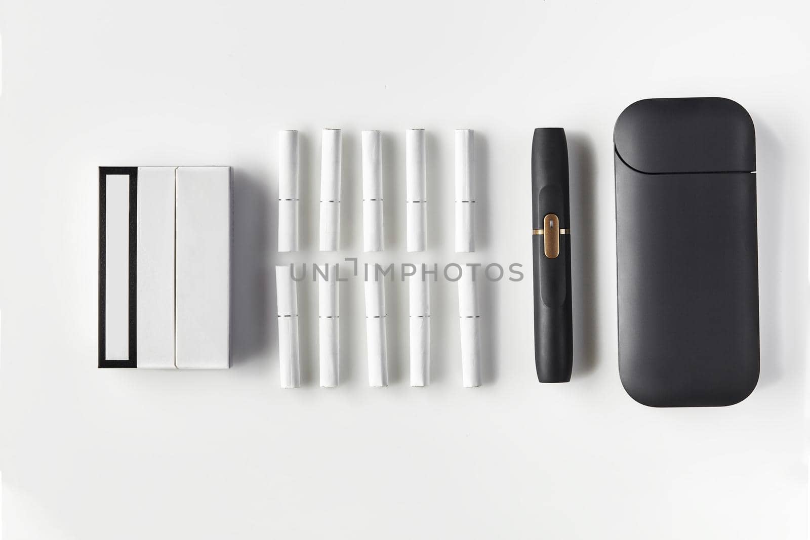 New generation black electronic cigarette and battery, pack and ten heatsticks isolated on white. New technology. Heating tobacco system. Close up by nazarovsergey