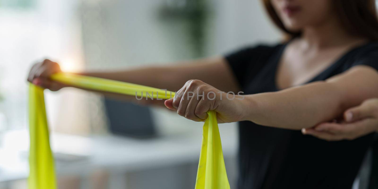 Doctor or Physiotherapist working examining treating using rubber Bands. Rehabilitation therapy concept