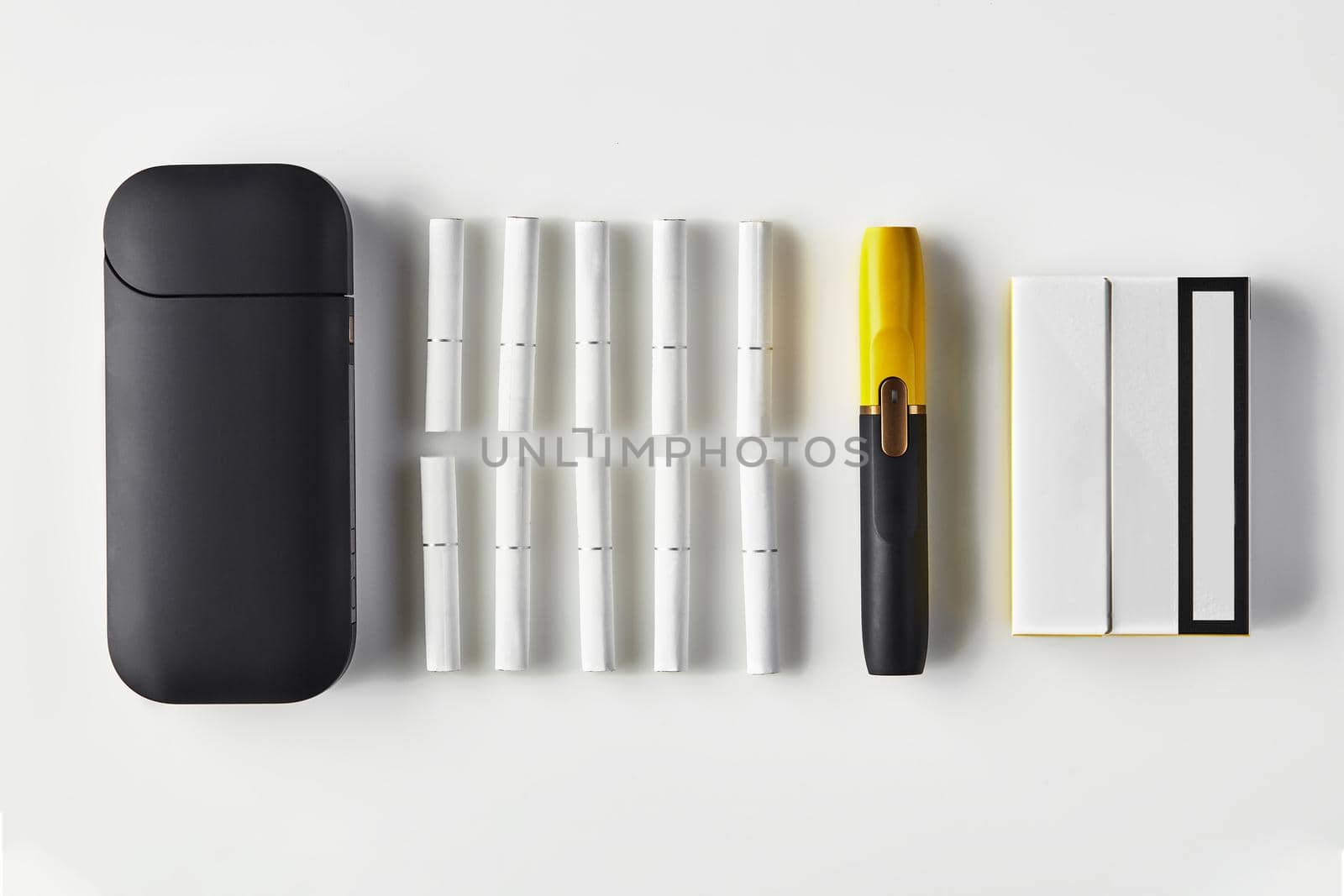 New generation black and yellow electronic cigarette and battery, one pack and ten heatsticks isolated on white. Heating tobacco system. Close up by nazarovsergey